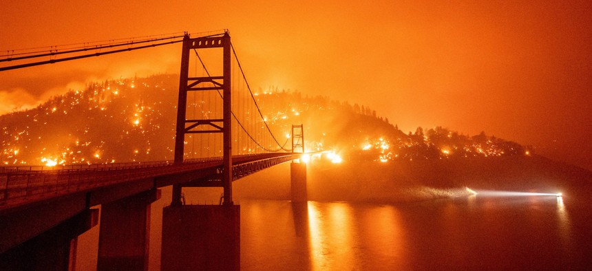 The Bidwell Bar Bridge is surrounded by fire in Lake Oroville during the Bear fire in Oroville, Calif. on September 9, 2020. NASA and the FAA are collaborating on an effort to use drone technology to battle wildfires.